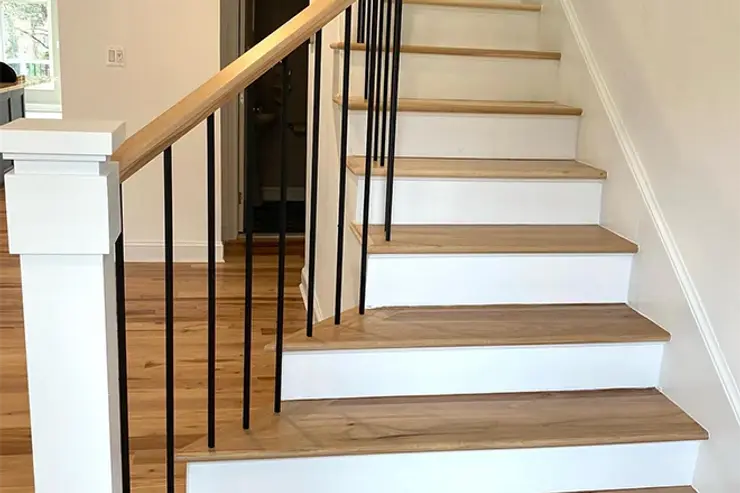 Oak staircase with white risers and black metal spindles