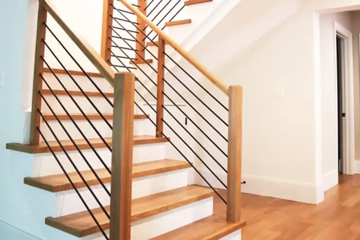 End of custom stairs with cable spindles and wood handrail