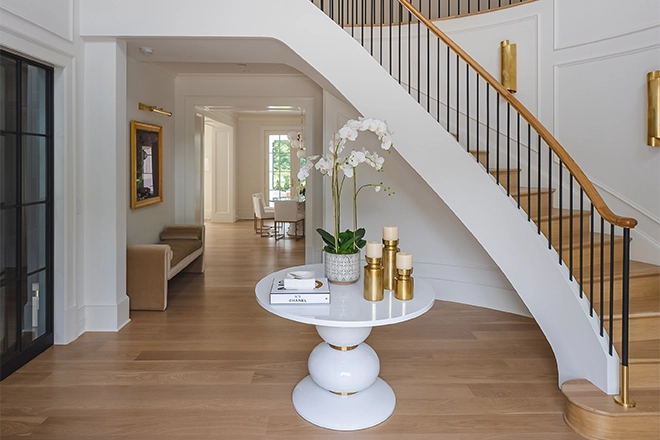 Entryway staircase ideas can include a table with plants