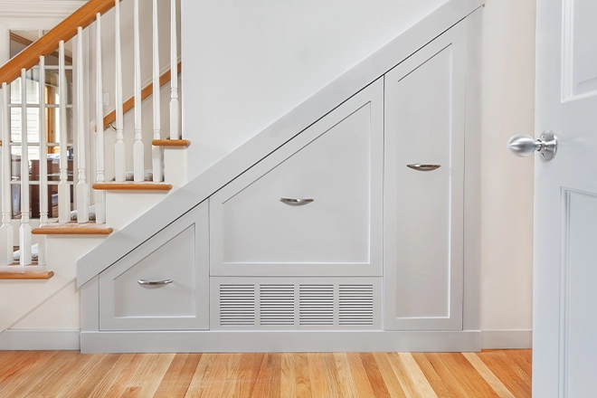 Under stair storage ideas like these angled cabinets