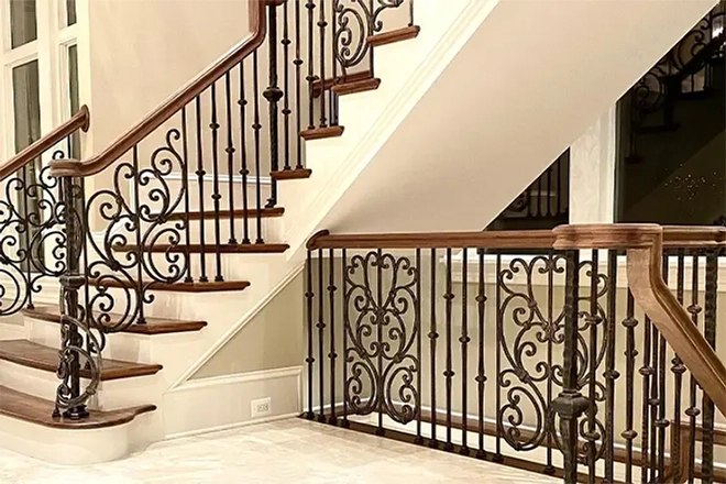 Home staircase with wood stair tread and custom spindles on the railing