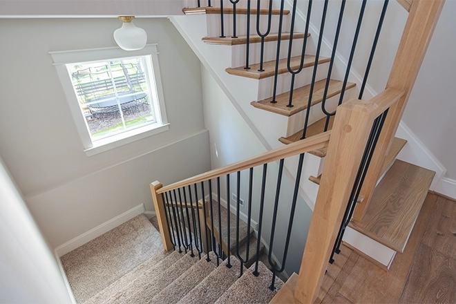 An L shaped staircase with carpet installed by Stair Creations