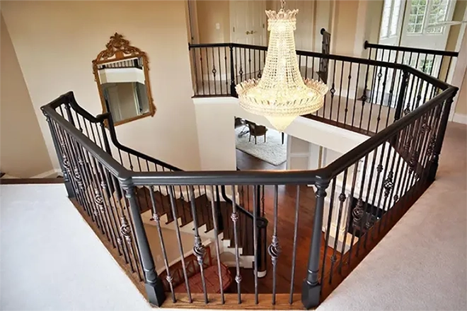 Looking down a dark wood custom staircase that curves downwards