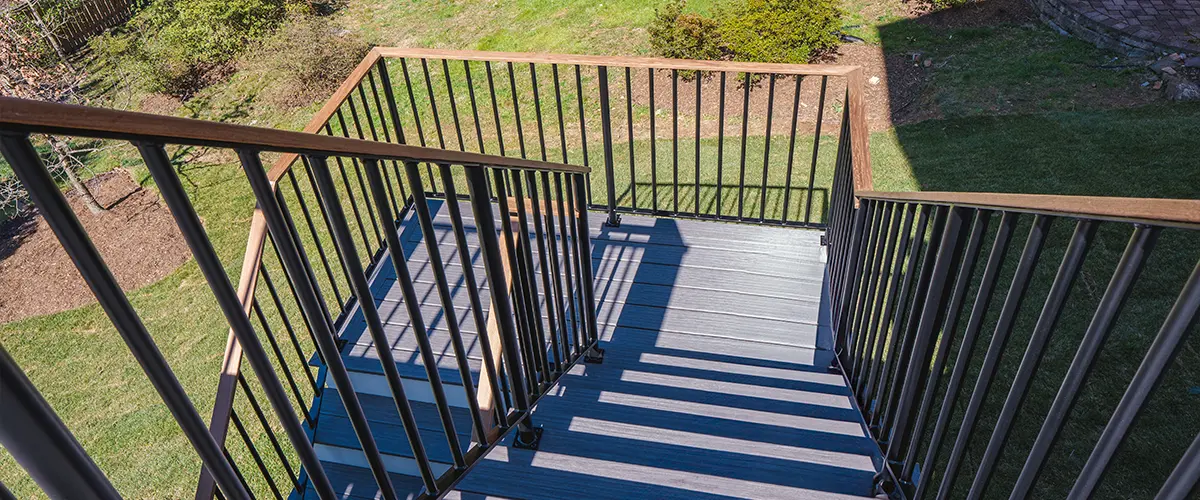 outdoor stair railing installation with metal balusters and deck steps