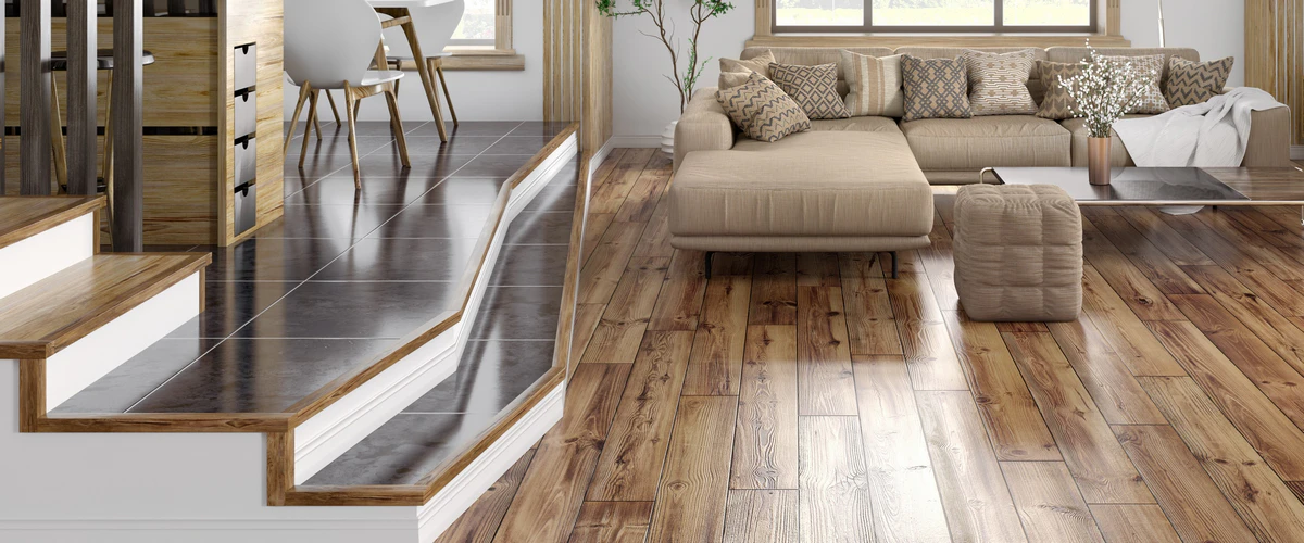 A modern living room featuring a textured, distressed hardwood floor that transitions smoothly into a slightly elevated, dark tiled floor space.