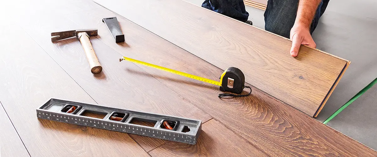 measuring and fitting hardwood floor planks during installation