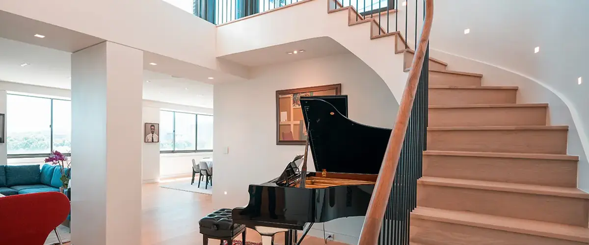Stair Design in McLean, VA 15 Curved hardwood staircase with black iron railing in luxury open-concept home interior