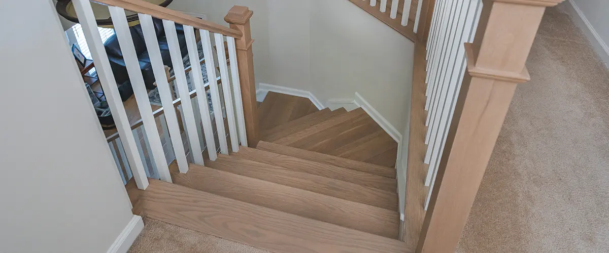 Stair Refinishing in Vienna, VA 15 Hardwood staircase with white balusters and custom wood handrails in residential interior