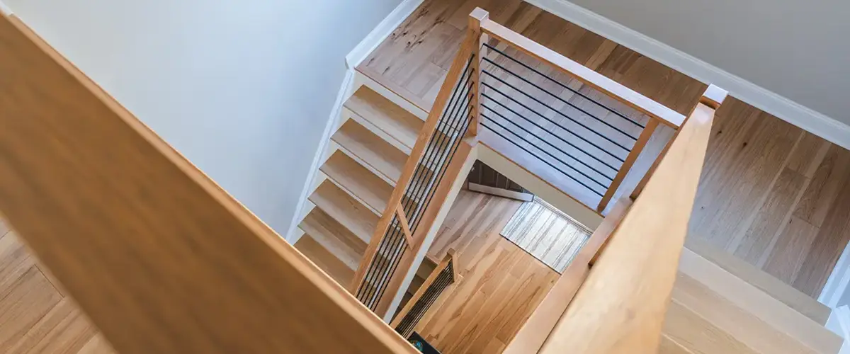 Stair Railing Installation in Springfield, VA 2 Modern hardwood staircase with horizontal cable railing viewed from upper landing