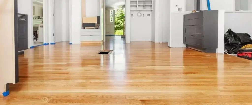 How to Acclimate Hardwood Flooring (Without Wrecking Your Floor) 2 Refinished hardwood flooring in modern home interior with glossy natural wood finish