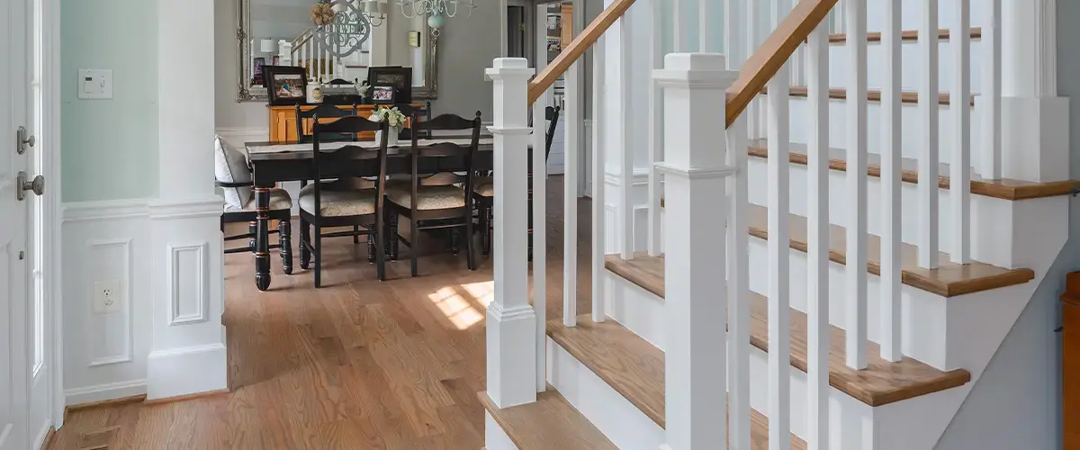 Stair Design in McLean, VA 2 Traditional wood staircase with white balusters and hardwood flooring in residential entryway